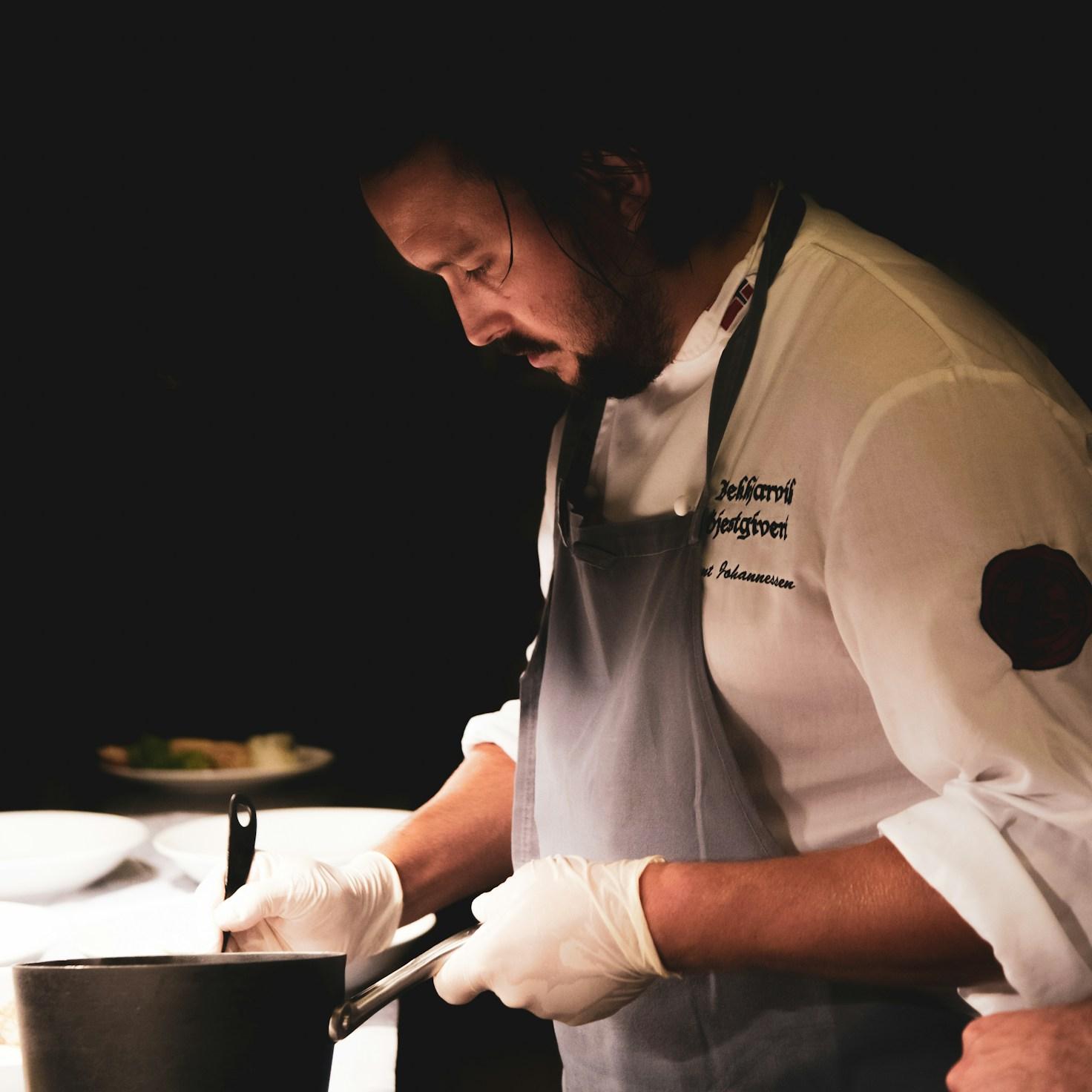 Community members collaborating in a modern kitchen space, sharing recipes and cooking techniques